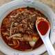 Hokkien Mee with spoon of chilli sauce